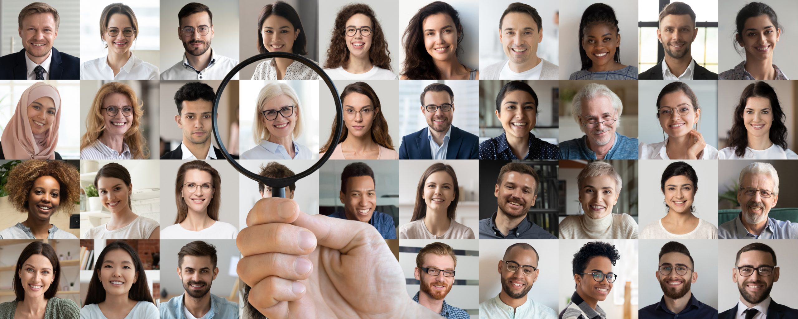 Employer,Hand,Holding,Magnifying,Glass,Choosing,Old,Middle,Aged,Female